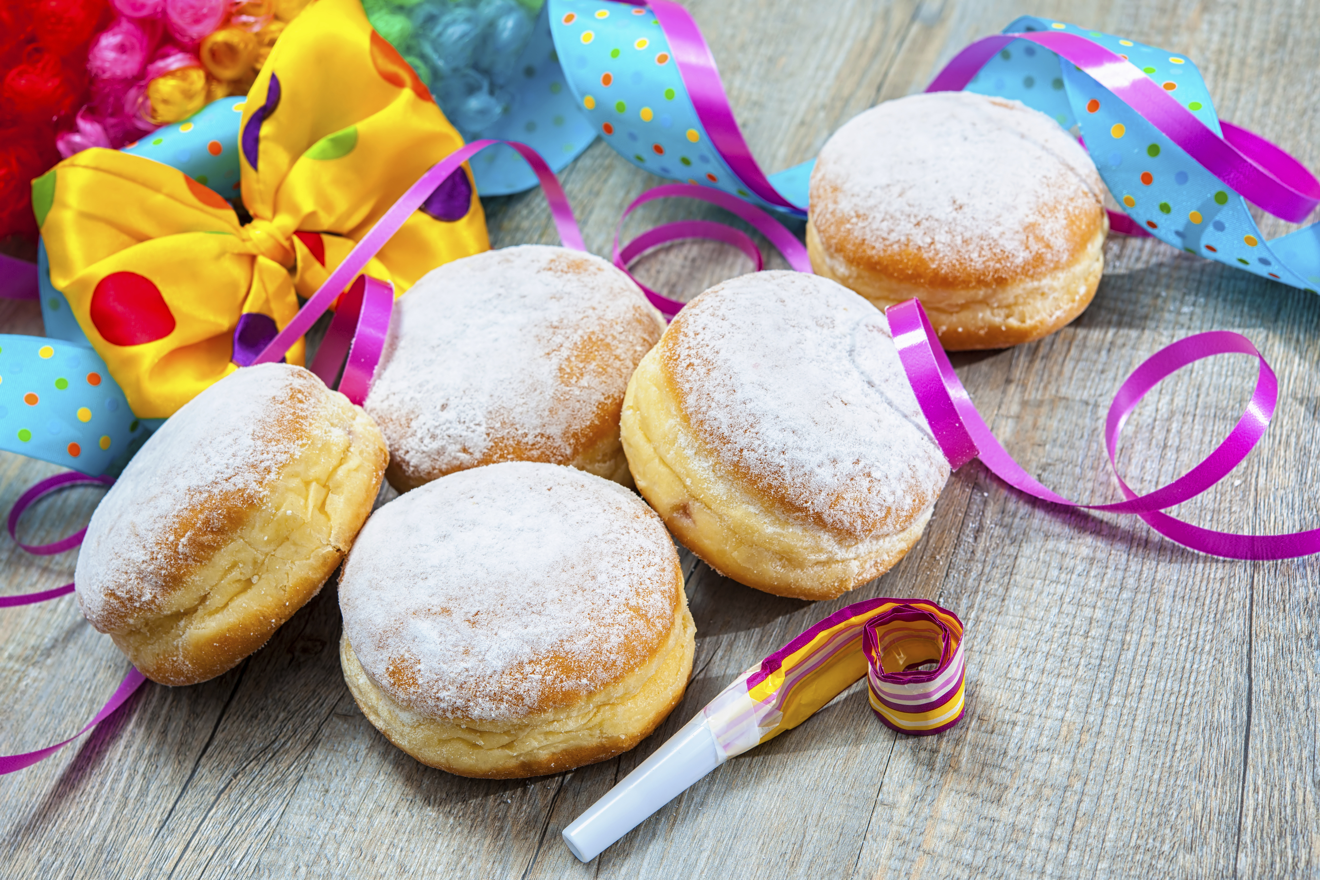 Krapfen or jelly doughnuts with jam and icing sugar